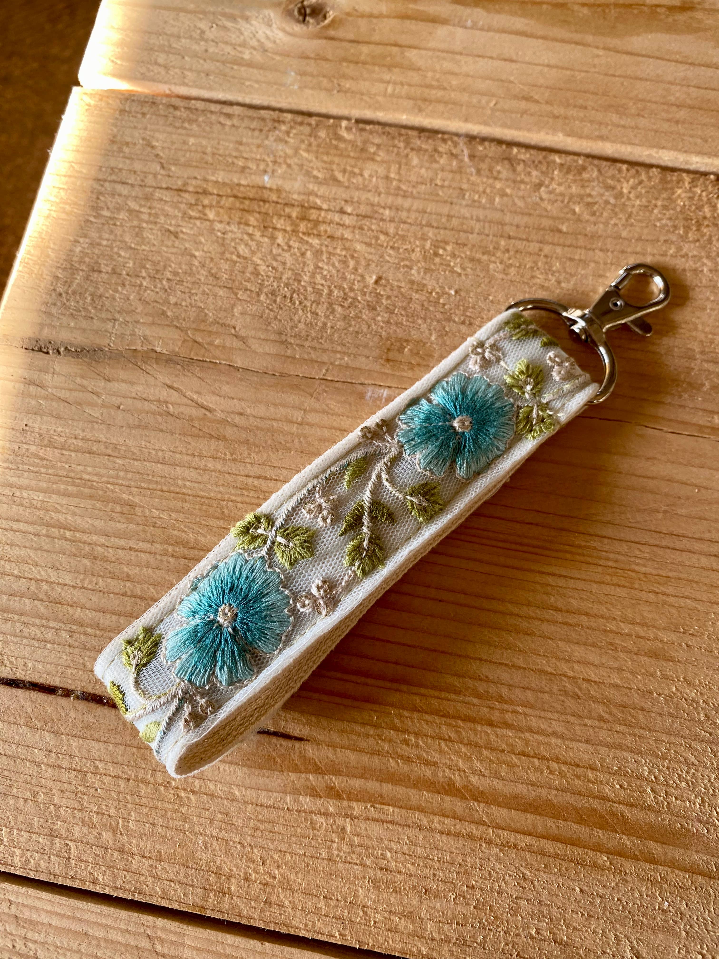 Blauer Schlüsselanhänger aus Stoff mit Blumenmuster und Haken zum Verschenken